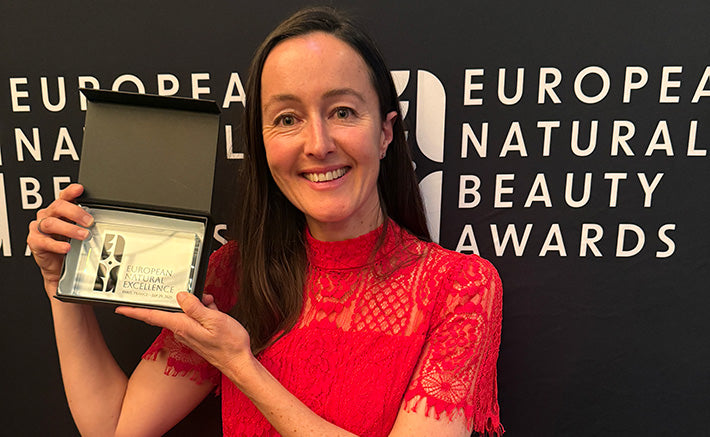Clemence Organics owner Bridget Carmady holding the 2025 European Natural Beauty Awards 'Natural Excellence' award.