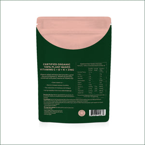 The back of a dark green stand-up pouch with a dusty pink resealable top, showing supplement facts and text for Certified Organic 100% Plant Based Vitamins C + D + K + Zinc.