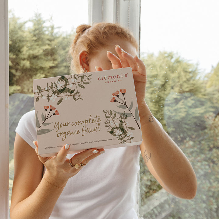 A woman holding the Clémence Organics product 'Mini' Face Essentials.