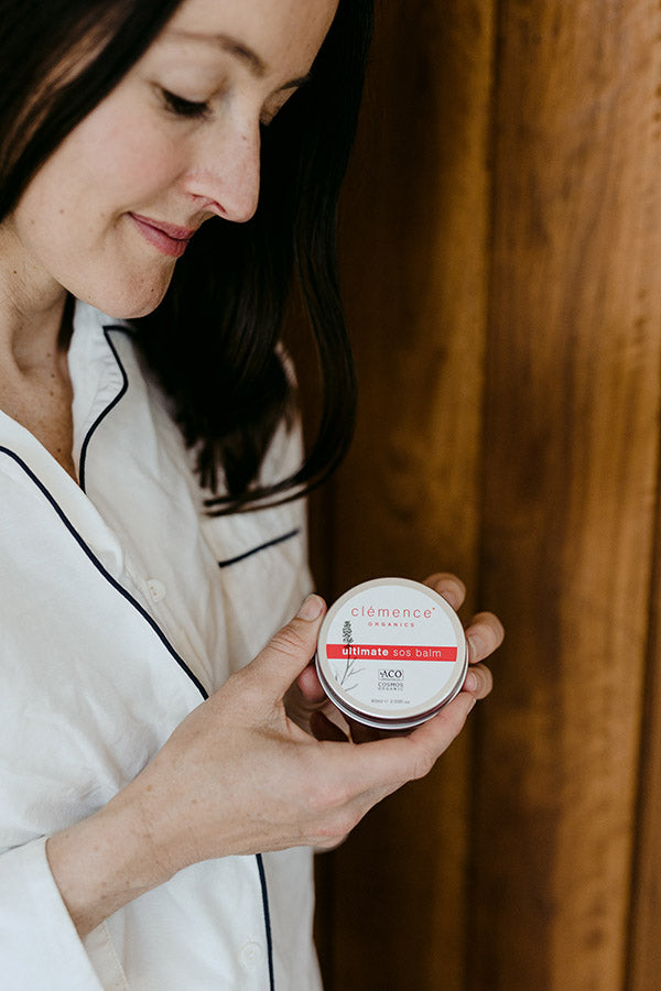 A woman holding a skin care product.