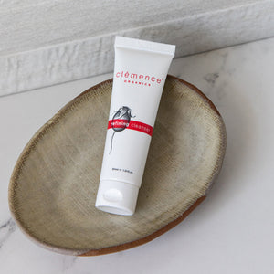Tube of Clémence Organics refining cleanser on a stone surface.