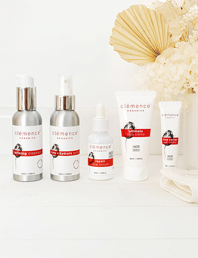 Five organic skincare products, against a white background with floral elements, that have been developed for the treatment of Eczema and Dermatitis.