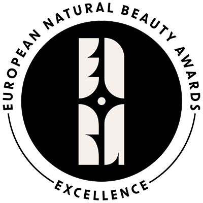 A circular black and white European Natural Beauty Awards Excellence badge with stylized lettering.